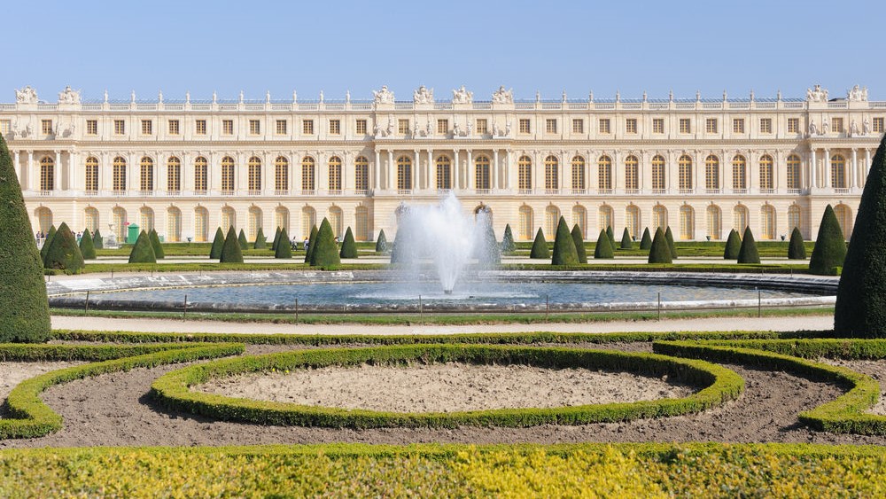 Palace-of-Versailles-Courtyard a tall tower in a city
